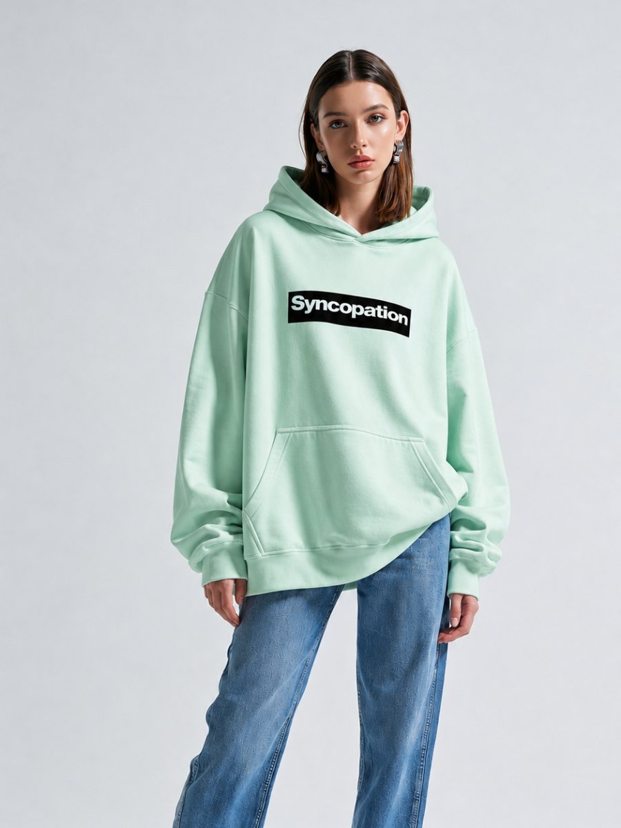Close detail of the mint hoodie fabric and print
