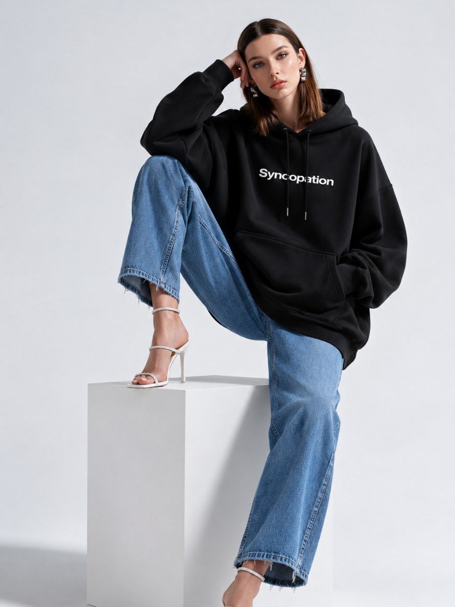 Wordmark hoodie photographed seated in the studio
