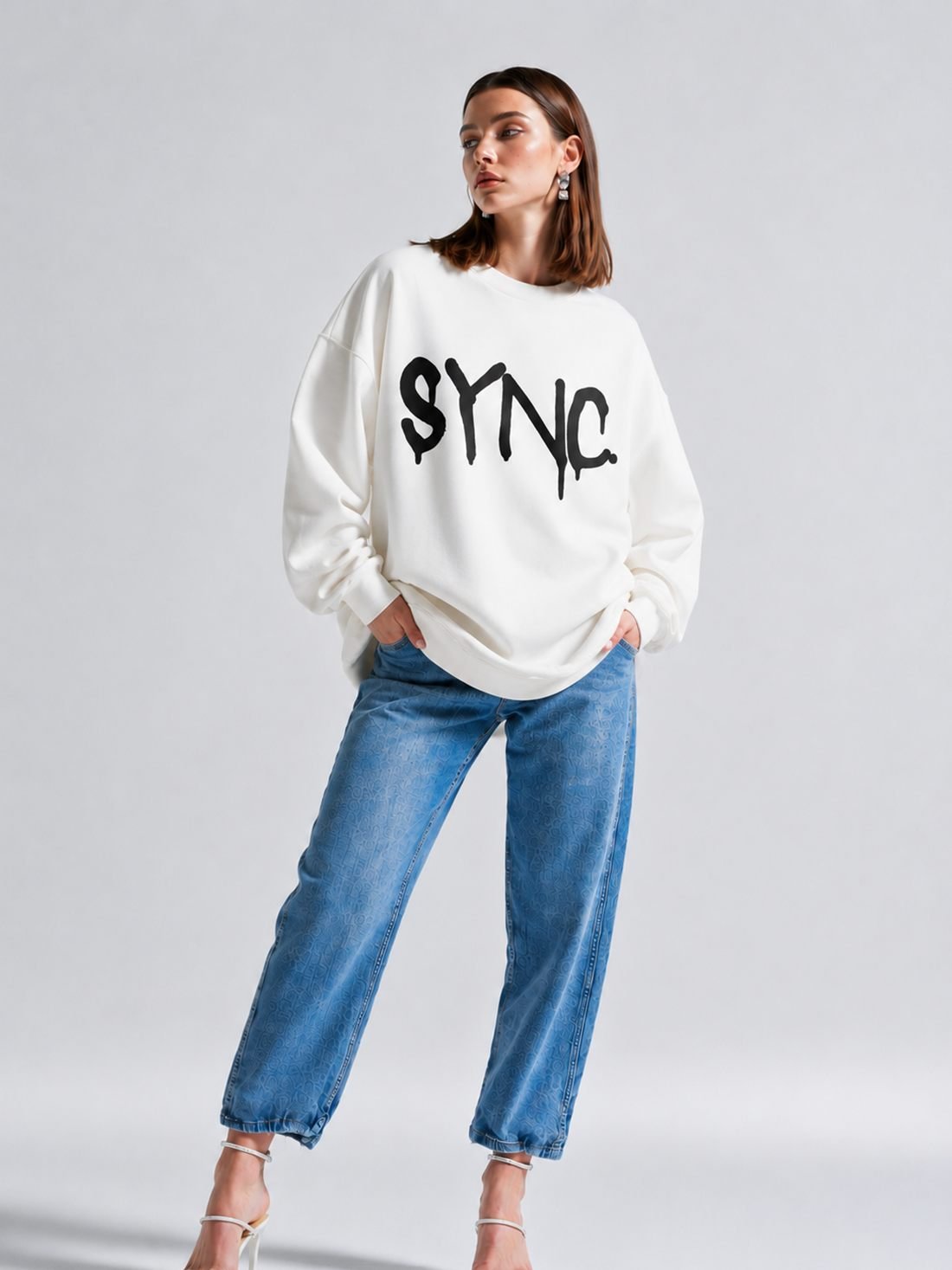 SYNC. crewneck in bone with the SYNC. graffiti mark across the chest