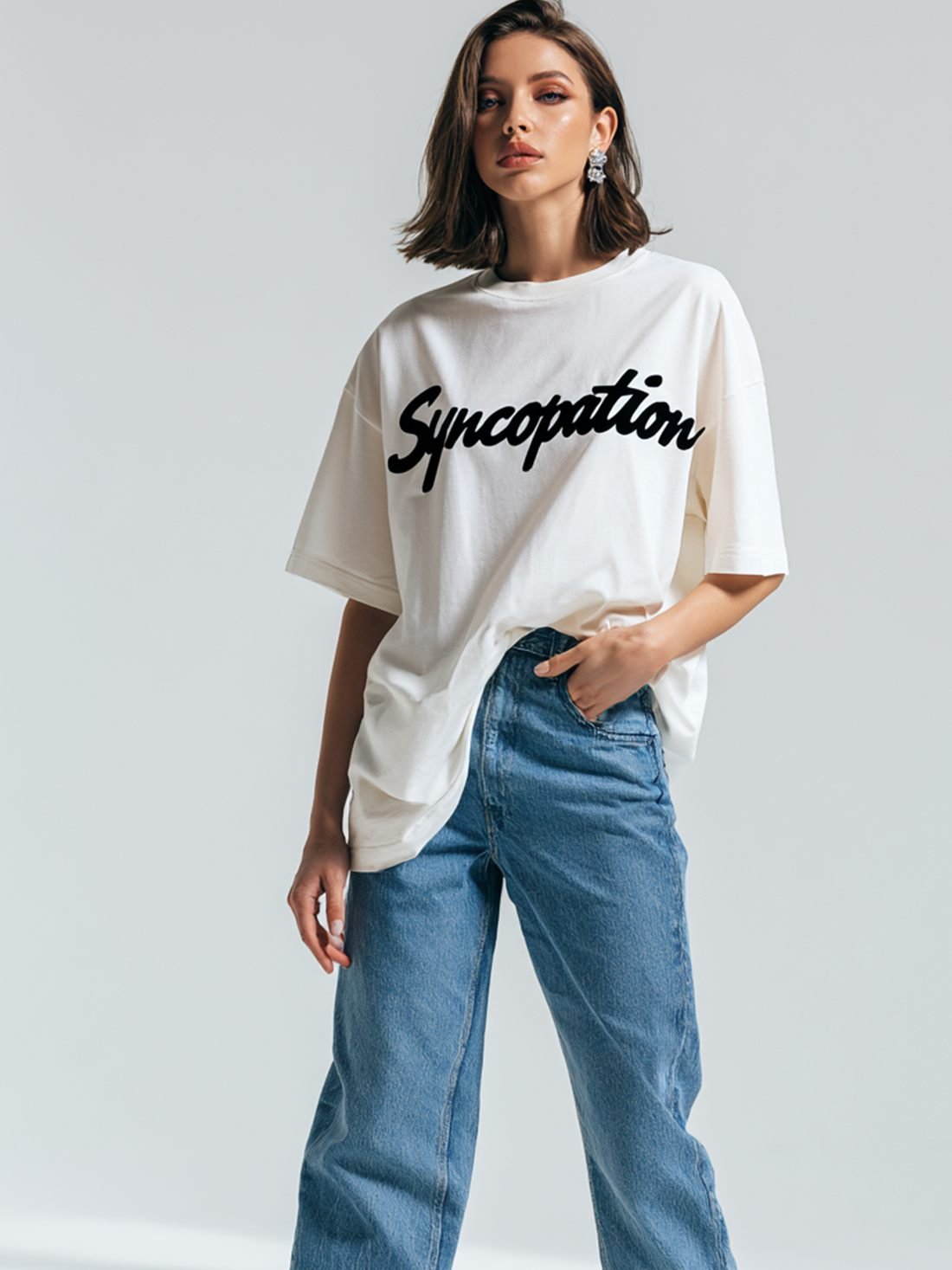 Script tee in bone with the Syncopation script logo across the chest